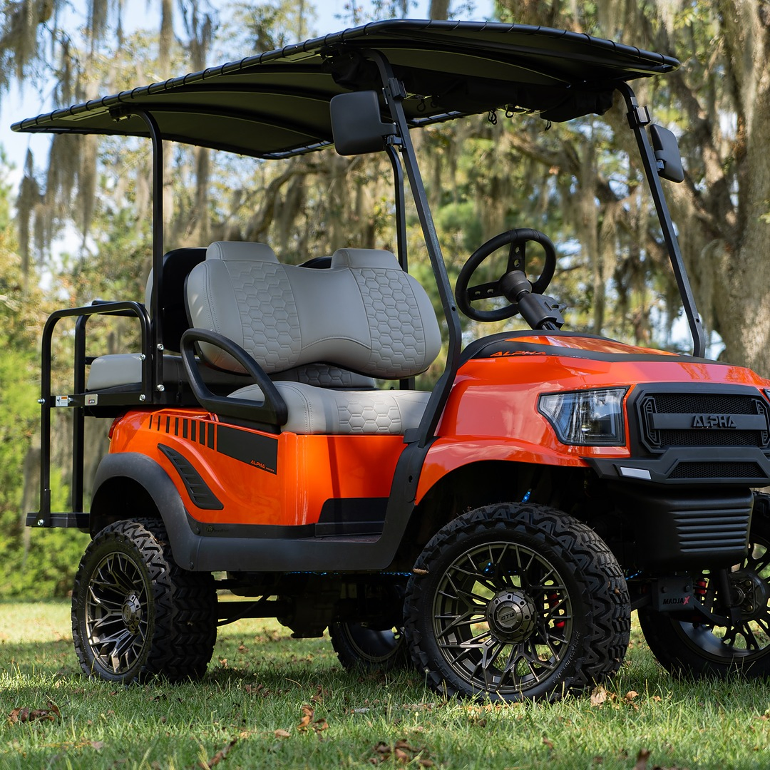 Red golf cart upgraded with MadJax body kit, side-facing view